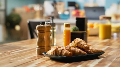Empty kitchen table with croissants and homemade food for breakfast Foto stock