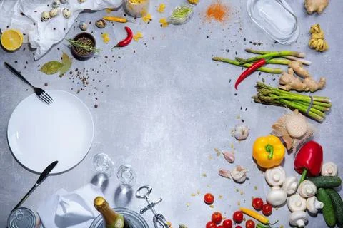 Empty kitchen table with vegetables and spices for cooking Stock Photos