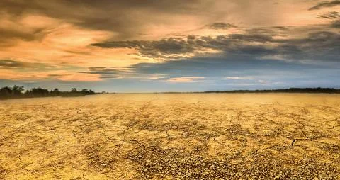 Empty land during sunset with clouds Stock Photos