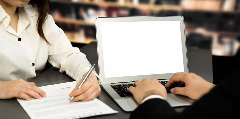 Empty laptop computer screen for astute design mockup on a table in library Stock Photos
