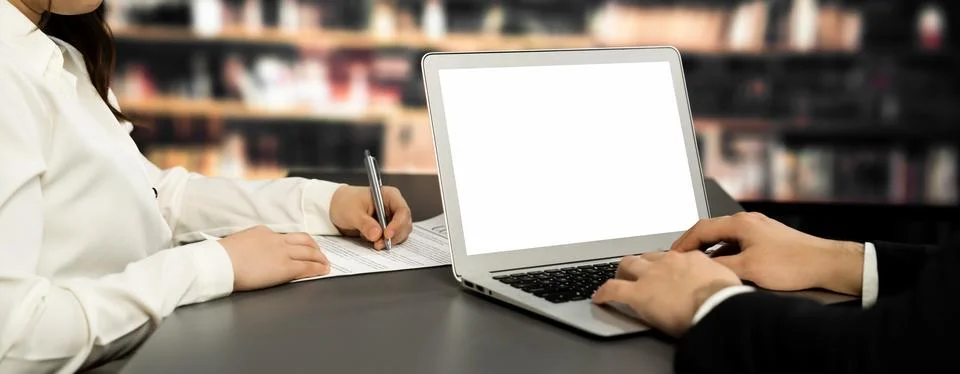 Empty laptop computer screen for astute design mockup on a table in library Stock Photos