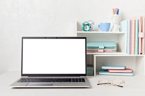 Empty laptop screen, desktop organizer with desk shelves and office supplies Stock Photos