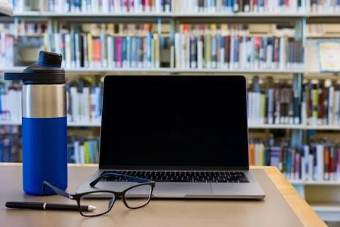 Empty laptop screen in library work or study space Stock Photos