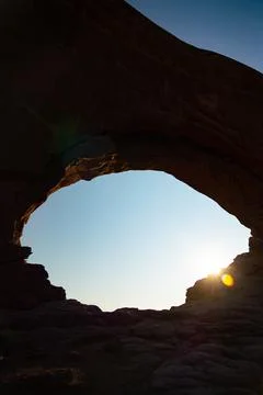 Empty large arch in the desert during sunrise 스톡 사진
