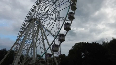Empty large Ferris wheel with blinking lights on a cloudy afternoon Stock Footage 71958155
