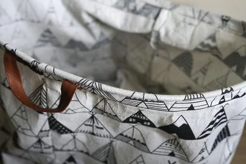 Empty laundry basket, canvas hamper bag, morning light 스톡 사진