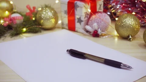 An empty leaf with a rune on a decorated table. Letter to Santa Claus. Vídeo Stock 116442855