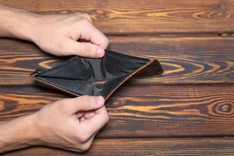 An empty leather wallet the in male hands, Top view Stock Photos