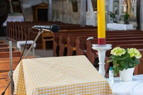 Empty lectern with a microphone in an empty church. Stock Photos