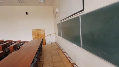 Empty lecture auditorium, green blackboard, wooden furniture on several levels Stock Footage 70371809
