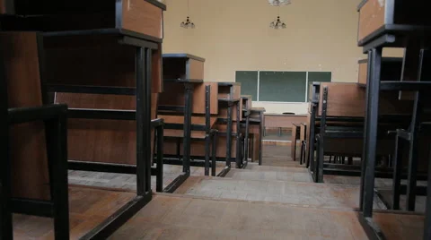 Empty lecture hall at the university. Lecture hall from the aisle between desks. Stock Footage 68965585