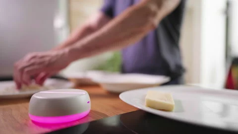 Empty light base hologram with person in background preparing meal in kitchen 4K 스톡 동영상 208643581