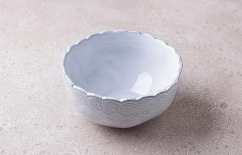 Empty light blue ceramic bowl on a beige textured background, mockup, for Stock Photos