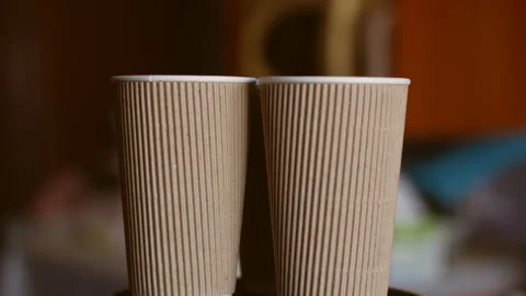 Empty light brown corrugated eco cups. disposable paper cups. Rotation. Close-up Stock Footage 116671170