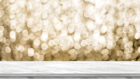 Empty light grey marble glossy table top with blur sparkling gold bokeh abstr Stock Photos