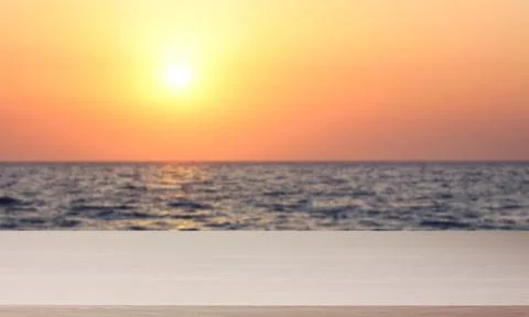 Empty light table against the background of a sea sunset. Stock-Fotos