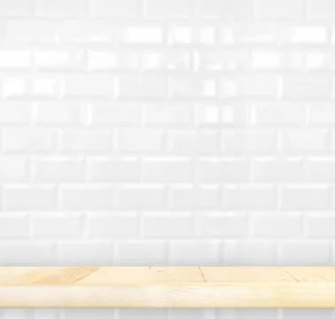 Empty light wood table and white ceramic tile brick wall in background,Mock.. Stock Photos