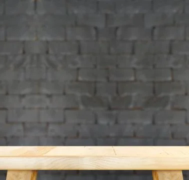 Empty light wood table and blur black brick wall in background,Mock up temp.. Stock Photos
