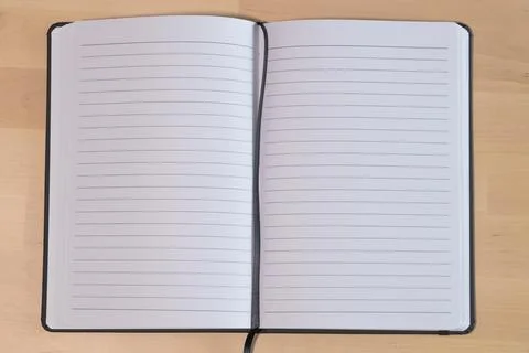 Empty lined notebook on wooden table. Ruled paper notebook Stock Photos