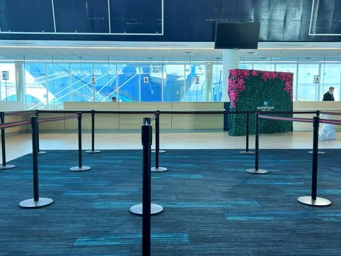 Empty lines where people should be checking into a cruise Stock Photos
