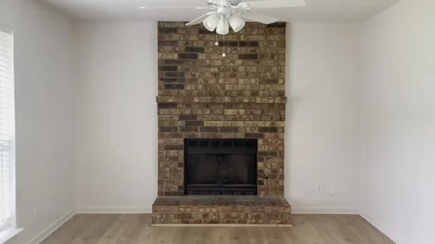 Empty Living Room with Brick Fireplace and Wood Floor Stock Footage 345844957