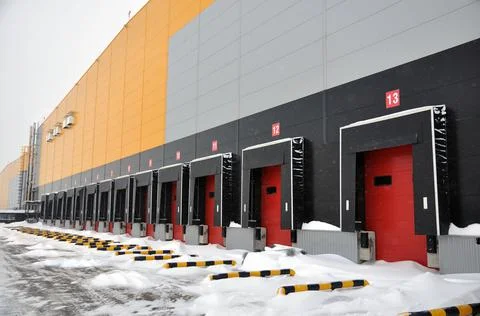 Empty loading area of a large warehouse in winter. Warehouse logistics comple Stock Photos