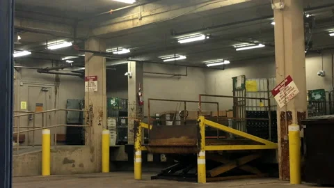 Empty loading dock for trucks to load up or deliver items.  Several bays Video stock 144497805