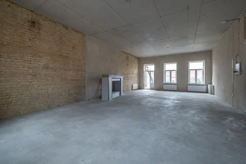 Empty loft room with brick wall and repair and without furniture for office Stock Photos
