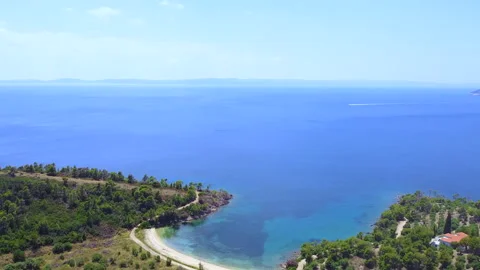 Empty lone sandy beach surrounded withwild nature and blue sea. Aerial view Stock Footage 135321072