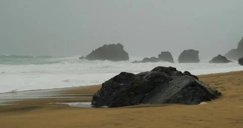Empty lonely cinematic beautiful beach in Portugal with big storm waves, fog Stock Footage 273503559