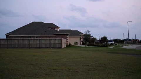 Empty Lot in front of a red brick new build home Stock Footage 316543322