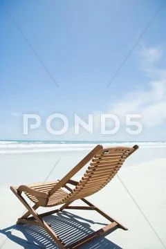 Empty Lounge Chair On Beach