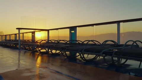 Empty lounge chairs on cruise ship deck at sunrise 動画素材 337304872