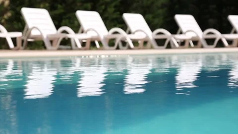 Empty Lounge Chairs by Swimming Pool Stock Footage 339701956