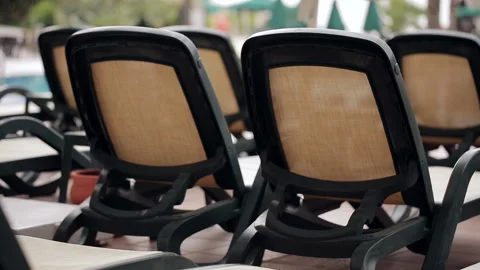 Empty Luxury sunbeds onswimming pool Stock Footage 100892183