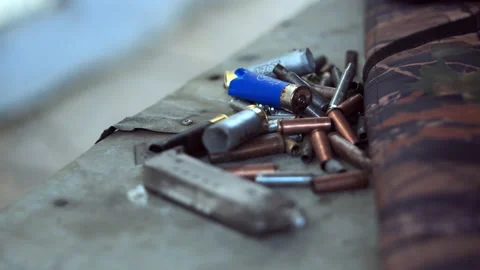 The empty machine gun shells.  Stock Footage 142627000