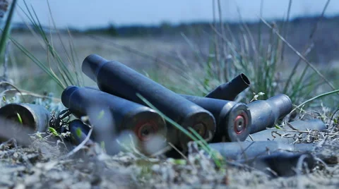 The empty machine gun shells in the grass Stock Footage 62115229