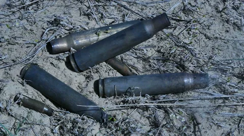 The empty machine gun shells in the grass Stock Footage 62205169