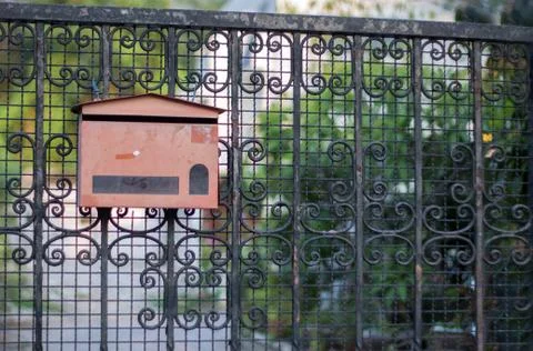 Empty mail box front of the gate Stock Photos