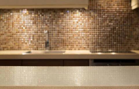 Empty marble countertop with blurred kitchen in the background Stock Photos