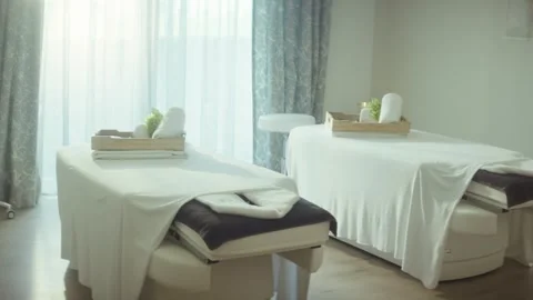Empty Massage Room with Two Treatment Tables, Bright Wellness Spa, Wide Shot Stock Footage 341427503