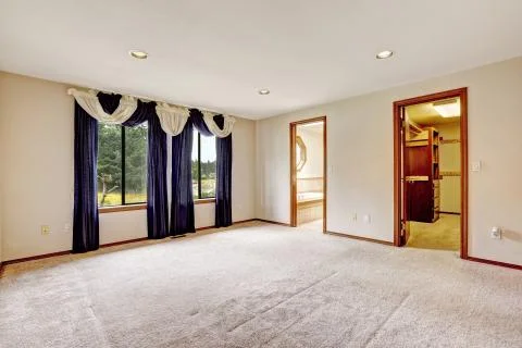 Empty master bedroom interior with walk-in closet and bathroom Stock Photos