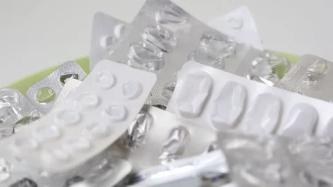 Empty medicine pill blisters rotating in seamless loop Stock Footage 154309020