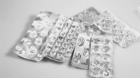 Empty medicine pill silver metallic tablets falling on the white surface Stock Footage 26352698