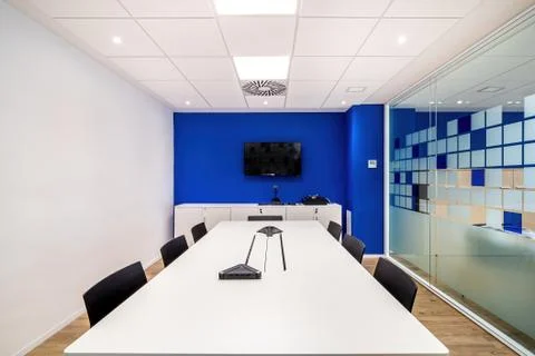 Empty meeting room for conversation with table, chairs, television in modern Фото