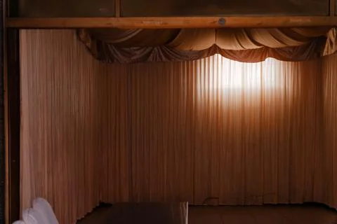 Empty Memorial Hall with Draped Curtains in Sunlight at Taoyuan Funeral Parlo 写真素材