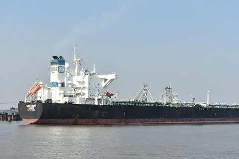 Empty Merchant big ship standing in a port in a vast water Stock Photos