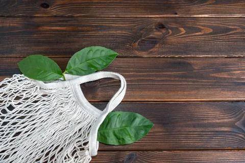 Empty Mesh String bag on old wooden background. Stock Photos
