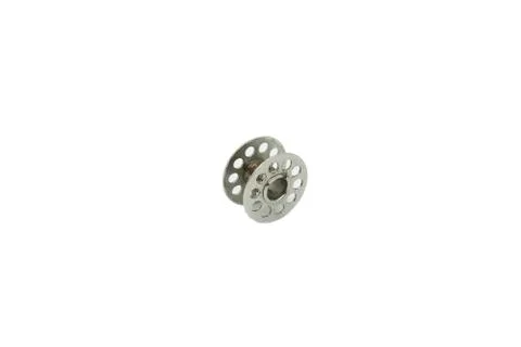 Empty metal bobbin for sewing machine close-up isolated on white background. Stock Photos