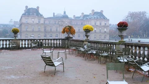 Empty Metal Chairs and Senate in Luxembourg Gardens Covered in Snow Stock Footage 317677706
